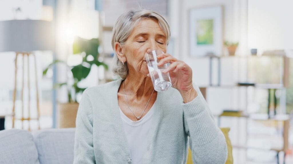 Older Woman Drinking a Glass of Water