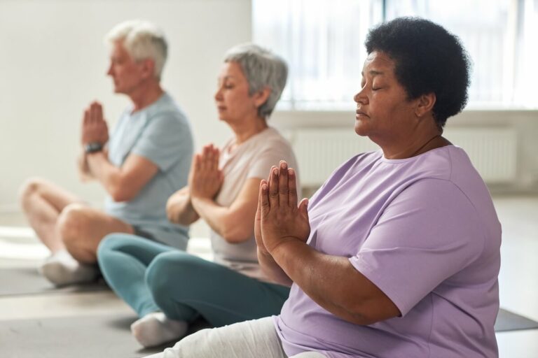 Group of older adults practicing yoga.