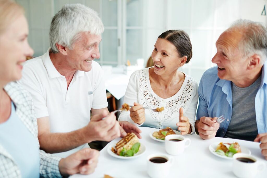 seniors making friends over a meal